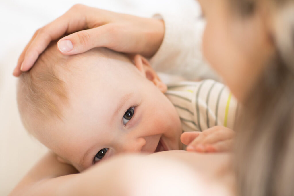 Picture of baby feeds mom’s breast